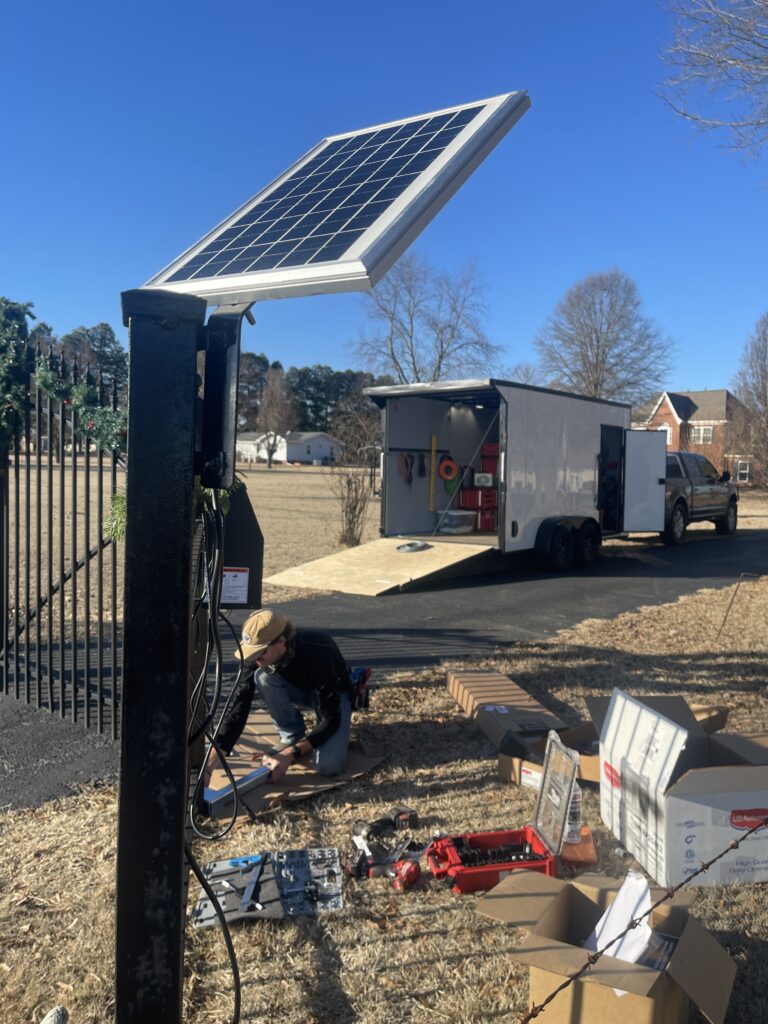 Solar panel being mounted for a gate power system by Inlay Automation at a Collierville, TN rural property
