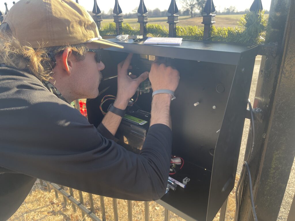 Inlay Automation technician diagnosing and repairing an electric gate motor at a Memphis, TN property